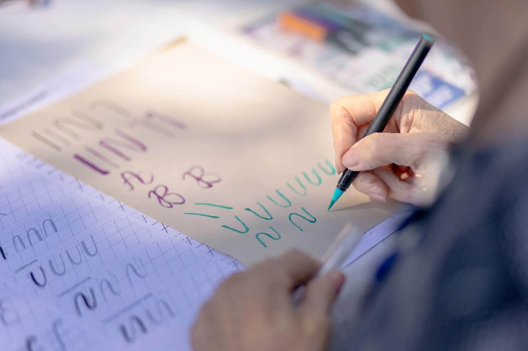 A close-up image of hand-lettering art on paper