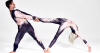 Duo AussieBela acrobats in a hand-to-hand balance pose, demonstrating precision and trust